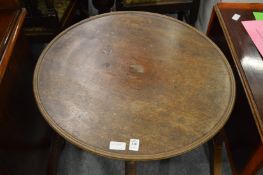 A mahogany circular tripod table.