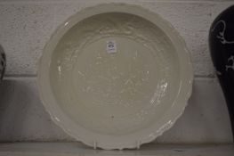 A Chinese blanc de chine circular dish with incised decoration.