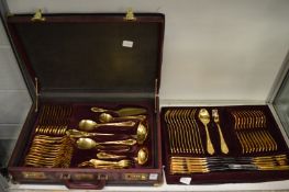 A fitted case containing a canteen of bronzed cutlery.