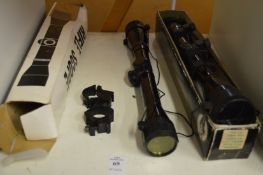 Two telescopic sights, boxed.