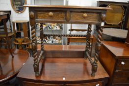 An oak two drawer side table.