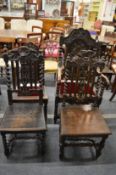 Four carved oak dining chairs, one with arms.