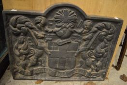 Cast iron fire back and a modern mirror.