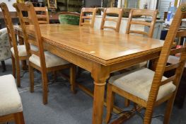 A good modern rectangular extending dining table with one leaf together with a set of eight matching