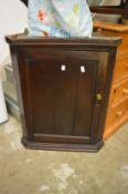 An oak hanging corner cupboard.