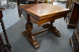 An unusual miniature oak drawer leaf dining table.