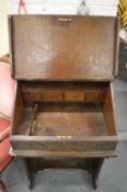 An 18th century oak clerks desk on stand.