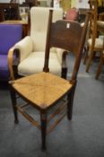 A set of four Arts and Crafts oak and rush seated dining chairs.