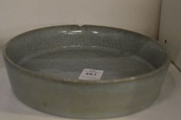 A celadon glazed shallow circular Chinese brush washer.