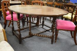 An oak drop leaf gateleg dining table.