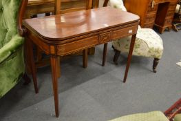 A George III mahogany and inlaid D shaped fold-over tea table on tapering square legs.