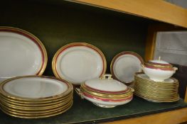 Maple & Co, London, a comprehensive dinner service with gilt and red borders.