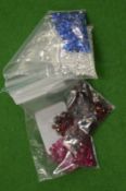 Various bags of coloured spinels.