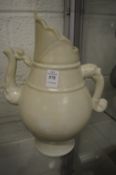 A large pale celadon glazed Chinese ewer.