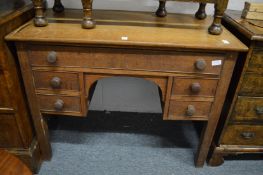 An oak kneehole desk.