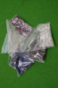 Various bags of coloured spinels.
