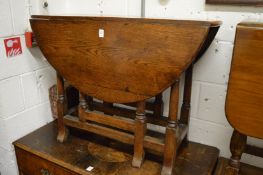 An oak drop leaf gateleg dining table.