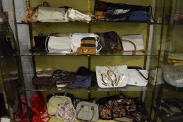 A large quantity of ladies handbags, holdalls etc.