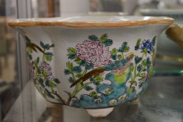 A Chinese jardiniere painted with birds and flowers.