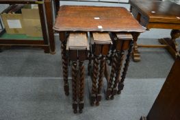 An unusual nest of three oak folding tables.