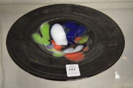 A moulded glass dish with colourful decoration.