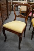 A set of eight Victorian mahogany balloon back dining chairs with carved cabriole front legs.