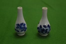 A pair of miniature Chinese blue and white bottle vases.
