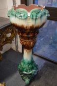 A Victorian majolica glazed jardiniere with matching stand.