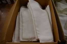 Four boxes of white table linen etc.