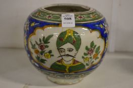 An Islamic pottery bowl painted with three panels depicting busts of a gentleman.