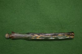 A long facated and gilded glass scent bottle with stopper.