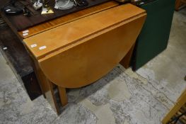 A modern drop leaf gateleg dining table.