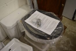 A Victorian style porcelain toilet basin with cistern, seat and accessories (unused).