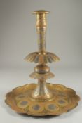 A LARGE 19TH CENTURY PERSIAN QAJAR SILVER INLAID ENAMELLED BRASS CANDLESTICK, 39cm high.