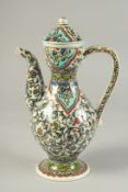 A TURKISH KUTAYHA GLAZED POTTERY LIDDED EWER, painted with floral decoration, 27cm high.