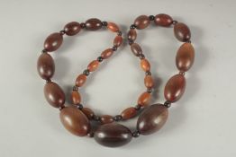 A GRADUATED RHINO HORN BEAD NECKLACE.
