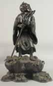 A LARGE 19TH CENTURY CHINESE BRONZE FIGURE OF LI TIEGUAI, elevated upon a large rock-formed bronze