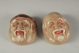 TWO ANTIQUE JAPANESE POTTERY FACE SAKE CUPS, 5cm and 5.5cm wide, (2).