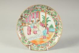 A CHINESE CANTON FAMILLE ROSE PORCELAIN PLATE, painted with a central panel of female figures and