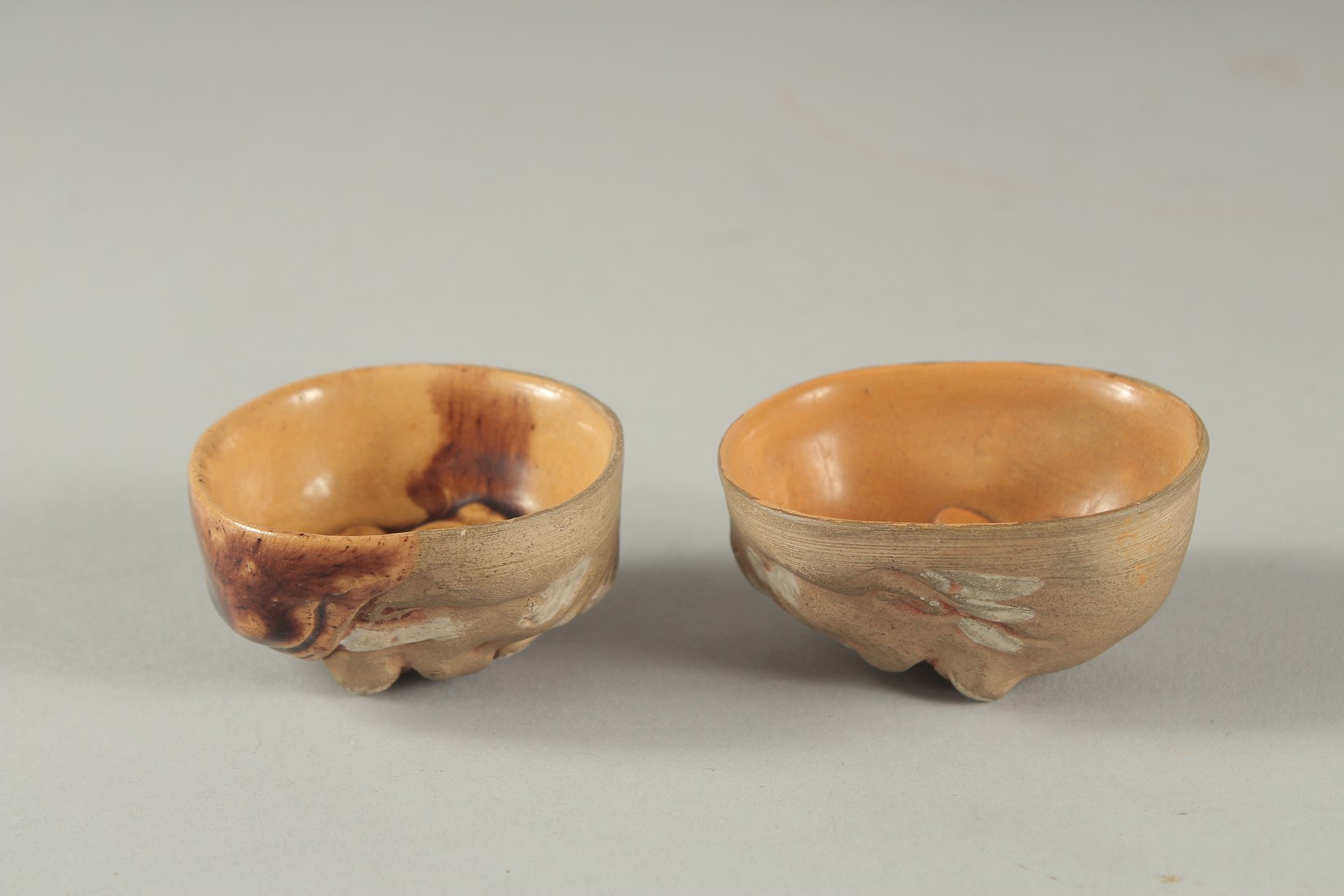 TWO ANTIQUE JAPANESE POTTERY FACE SAKE CUPS, 5cm and 5.5cm wide, (2). - Image 2 of 3