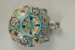 A 19TH CENTURY MOROCCAN GLAZED POTTERY WATER MOON FLASK, 21cm high.