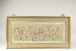 A CHINESE EMBROIDERED SILK 'HUNDRED CHILDREN' TEXTILE, framed and glazed, textile 30cm x 64cm. 406.