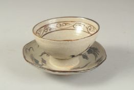 A CHINESE CIZHOU POTTERY TEA CUP AND TRAY.