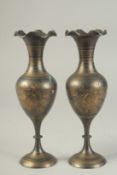 A PAIR OF INDIAN BRASS VASES, 23cm high.