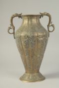A GOOD ISLAMIC ENGRAVED BRASS TWIN HANDLE VASE, with panels of finely engraved floral decoration,