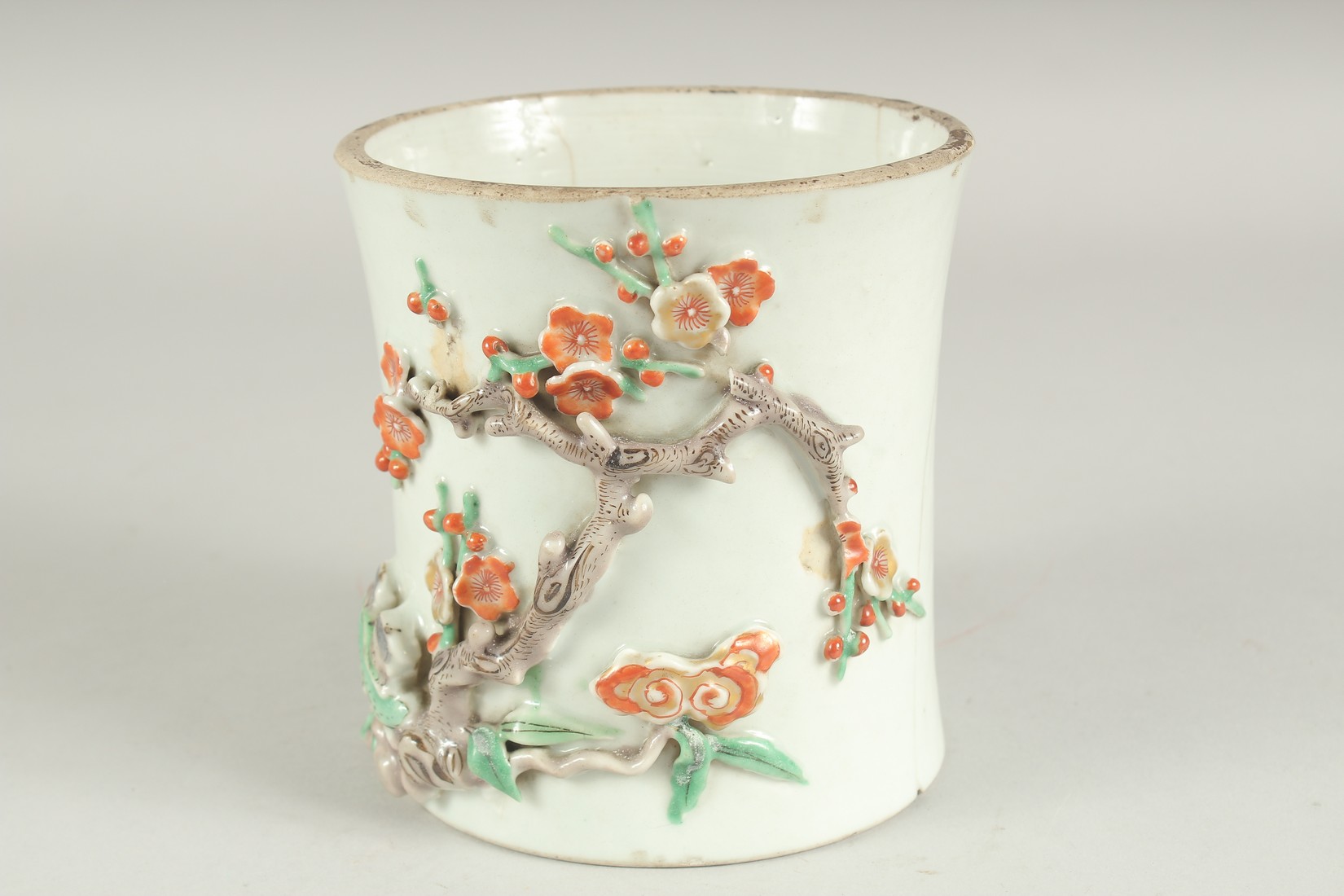 A CHINESE PORCELAIN RELIEF DECORATED SLEEVE SECTION - POSSIBLY FROM A VASE, the moulded relief
