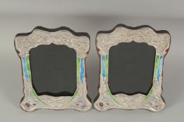 A PAIR OF SILVER AND ENAMEL PHOTOGRAPH FRAMES. 7.25ins x 5.5ins.