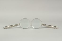 A PAIR OF CHROME HANDLE MAGNIFYING GLASSES.