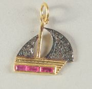 A SMALL GOLD RUBY AND DIAMOND CHARM in the form of a boat.