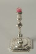 A GEORGE II SLVER TAPER STICK. London 1727, maker: James Gould. 12ins high.